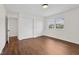 Spacious bedroom with hardwood floors, neutral walls and bright windows with outside views at 6838 Johnson Rd, Indianapolis, IN 46220