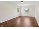 Bedroom featuring hardwood floors and two windows at 6838 Johnson Rd, Indianapolis, IN 46220