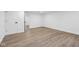 A clean bedroom offers hardwood floors and white walls to create an airy space at 6838 Johnson Rd, Indianapolis, IN 46220
