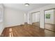 Bedroom featuring hardwood floors, mirrored closet doors, and a neutral color palette at 6838 Johnson Rd, Indianapolis, IN 46220