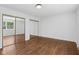 Bedroom with sliding closet doors, hardwood floors, and natural light at 6838 Johnson Rd, Indianapolis, IN 46220
