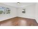 Bright bedroom has hardwood flooring, neutral walls, and windows providing natural light at 6838 Johnson Rd, Indianapolis, IN 46220