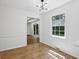 Bright dining area featuring hardwood floors and a window with a backyard view at 6838 Johnson Rd, Indianapolis, IN 46220