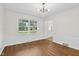 Bright Dining Room featuring hardwood floors, white walls, and a modern chandelier at 6838 Johnson Rd, Indianapolis, IN 46220