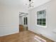 Bright dining area features stylish light fixture and hardwood floors at 6838 Johnson Rd, Indianapolis, IN 46220