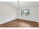 Bright Dining Room featuring hardwood floors, white walls, and a modern chandelier at 6838 Johnson Rd, Indianapolis, IN 46220