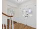 Welcoming entryway features wood floors and decorative glass on double front doors at 6838 Johnson Rd, Indianapolis, IN 46220
