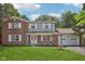 Charming two-story brick home with a well-manicured lawn and attached two-car garage at 6838 Johnson Rd, Indianapolis, IN 46220