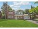 Charming two-story brick home with a well-manicured lawn and attached two-car garage at 6838 Johnson Rd, Indianapolis, IN 46220