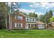Two-story brick home with a well-manicured lawn, mature trees, and an attached garage at 6838 Johnson Rd, Indianapolis, IN 46220