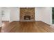 Living room with brick fireplace and hardwood floors at 6838 Johnson Rd, Indianapolis, IN 46220