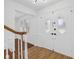 Bright foyer with beautiful white doors, wooden floors, and staircase at 6838 Johnson Rd, Indianapolis, IN 46220