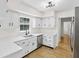 Updated kitchen features white cabinets, quartz countertops, and stainless steel dishwasher at 6838 Johnson Rd, Indianapolis, IN 46220