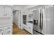 Bright kitchen featuring white cabinets, stainless steel appliances, and hardwood floors at 6838 Johnson Rd, Indianapolis, IN 46220