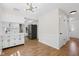 Open concept kitchen with white cabinets and stainless steel appliances at 6838 Johnson Rd, Indianapolis, IN 46220