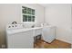 Laundry Room featuring a utility sink and washer and dryer at 6838 Johnson Rd, Indianapolis, IN 46220