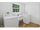 Functional laundry room featuring a sink, washer, and dryer at 6838 Johnson Rd, Indianapolis, IN 46220