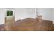 Bright living room with hardwood floors and windows, flowing into adjacent room at 6838 Johnson Rd, Indianapolis, IN 46220