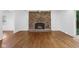 Cozy living room with a brick fireplace, hardwood floors, and access to an outdoor space at 6838 Johnson Rd, Indianapolis, IN 46220