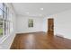 Bright living room features hardwood floors, recessed lighting, and a large window at 6838 Johnson Rd, Indianapolis, IN 46220