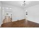 Open-concept living room with hardwood floors and white trim at 6838 Johnson Rd, Indianapolis, IN 46220