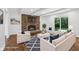 Stylishly staged living room featuring a brick fireplace and hardwood floors at 6838 Johnson Rd, Indianapolis, IN 46220