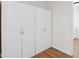 Storage area featuring white closets and hardwood floors at 6838 Johnson Rd, Indianapolis, IN 46220