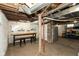 Unfinished basement featuring exposed ceiling, work bench and concrete flooring at 702 S Keystone Ave, Indianapolis, IN 46203
