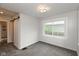 Cozy bedroom with neutral decor, plush carpeting, and barn-style door at 702 S Keystone Ave, Indianapolis, IN 46203