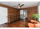 Cozy bonus room with wood paneled walls, a modern ceiling fan, and stylish orange chair at 702 S Keystone Ave, Indianapolis, IN 46203