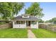 Charming bungalow-style home with a well-manicured lawn and inviting brick pathway at 702 S Keystone Ave, Indianapolis, IN 46203