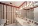 Bright bathroom featuring an extended white counter with a sink, large mirror and unique wallpaper at 7317 Lions Head Dr # A, Indianapolis, IN 46260