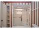 Bathroom featuring a shower-tub combo with sliding doors and built-in shelving in an adjacent closet at 7317 Lions Head Dr # A, Indianapolis, IN 46260