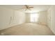 The large bedroom features a ceiling fan, a window with curtains, and neutral carpeted floors at 7317 Lions Head Dr # A, Indianapolis, IN 46260