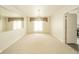 Bright dining area with chandelier, large windows with curtains, and wall mirror for ample lighting at 7317 Lions Head Dr # A, Indianapolis, IN 46260