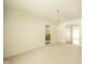Large dining area adjacent to the kitchen with carpet floors and a bright light fixture at 7317 Lions Head Dr # A, Indianapolis, IN 46260