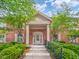 Brick building featuring a covered entryway with white columns, stairs, and manicured landscaping at 7317 Lions Head Dr # A, Indianapolis, IN 46260