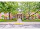 Attractive brick building featuring manicured landscaping, a covered entryway, and sidewalk access at 7317 Lions Head Dr # A, Indianapolis, IN 46260