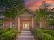 Stunning brick home featuring a covered entrance with white pillars and beautifully landscaped front yard at 7317 Lions Head Dr # A, Indianapolis, IN 46260