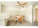 Eat-in kitchen area with a ceiling fan, a wooden table, and four chairs at 7317 Lions Head Dr # A, Indianapolis, IN 46260