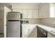 The kitchen features stainless steel appliances, white cabinets, and plenty of counter space at 7317 Lions Head Dr # A, Indianapolis, IN 46260