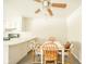 Cozy eat-in kitchen featuring a wooden table with four chairs, a ceiling fan, and modern laminate flooring at 7317 Lions Head Dr # A, Indianapolis, IN 46260