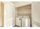 A spacious laundry room with a washer, dryer, and ample shelving for storage at 7317 Lions Head Dr # A, Indianapolis, IN 46260