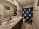 Bathroom features a double sink vanity, decorative shower curtain, and modern fixtures at 7511 Eddie Ln, Camby, IN 46113