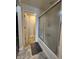 Neutral bathroom with frosted glass shower doors and grey floor mat at 7511 Eddie Ln, Camby, IN 46113