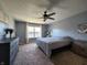 Bright bedroom with a ceiling fan, large window, and modern décor at 7511 Eddie Ln, Camby, IN 46113