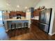 Modern kitchen with stainless steel appliances, a large island with seating, and ample cabinet space at 7511 Eddie Ln, Camby, IN 46113