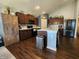 Bright kitchen with wooden cabinets, stainless steel appliances, and a functional island with barstool seating at 7511 Eddie Ln, Camby, IN 46113