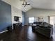 Spacious living room features a high vaulted ceiling, brick accent wall, and comfortable seating arrangement at 7511 Eddie Ln, Camby, IN 46113