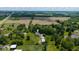 Areal shot showing the farm land with a residential home and outbuilding in the area at 7516 S County Road 300 W, Clayton, IN 46118